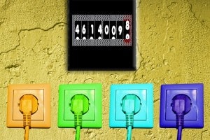 coloured plug sockets on wall with meter reading above