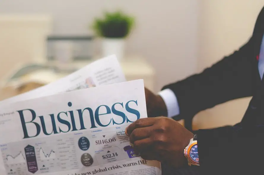 Business man reading business pages of newspaper