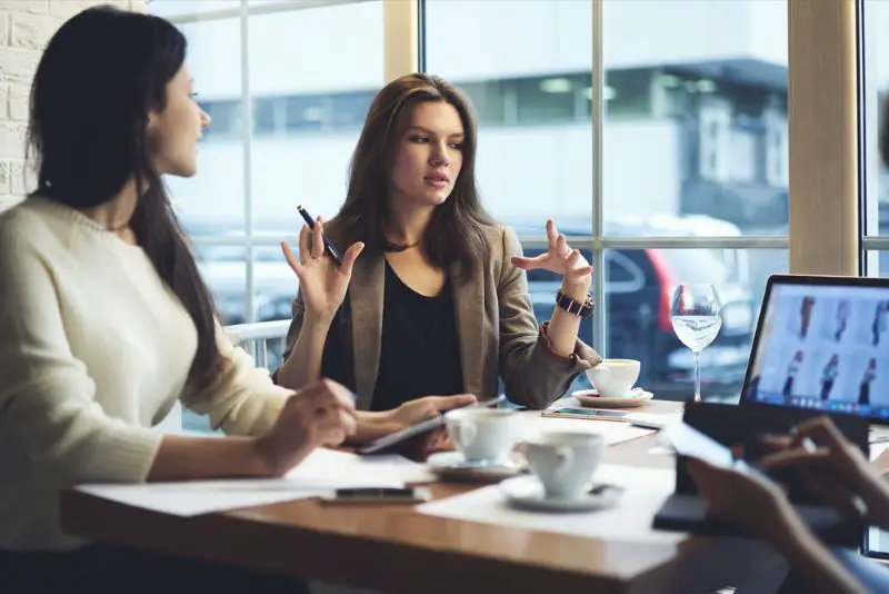 Skilled female leader of marketing experts working group explaining successful strategy for startup project