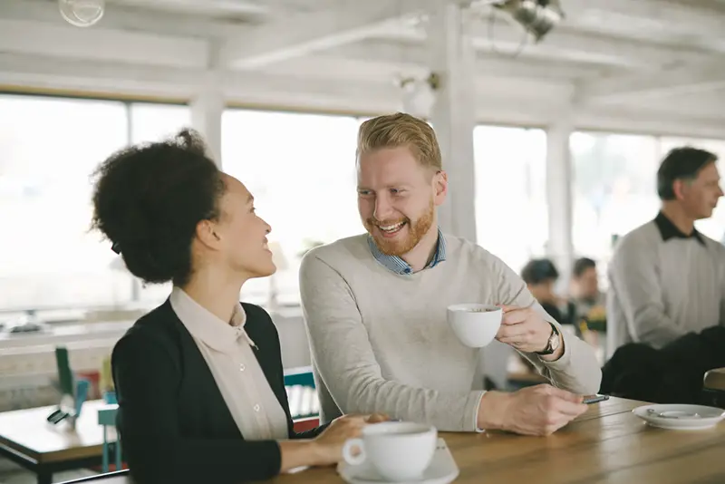 Male and female office colleague having a coffee break