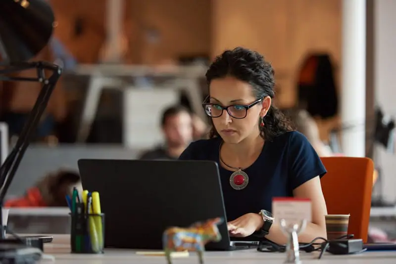 woman working on a laptop in an office