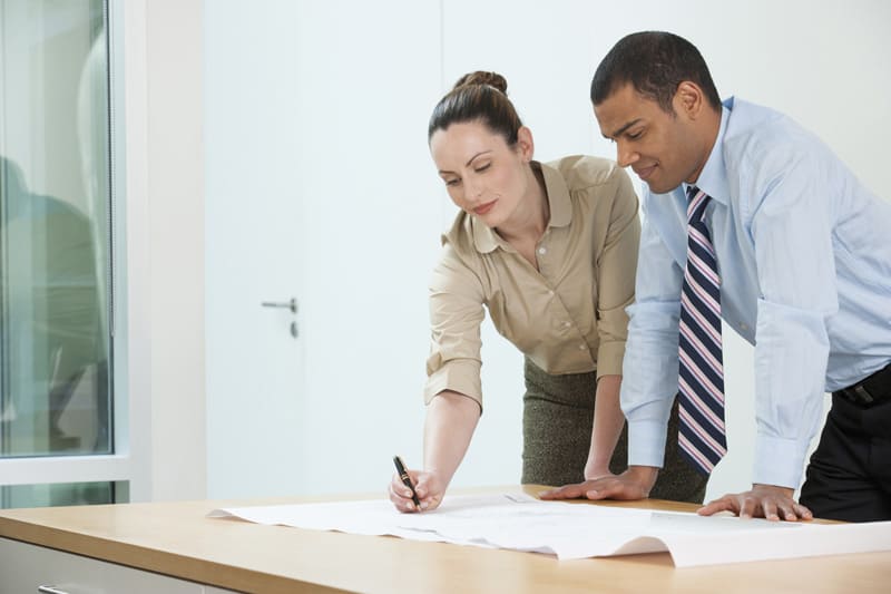 team members writing notes on document