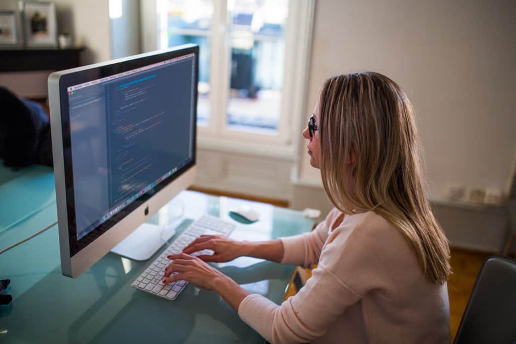 woman sat at a desk working on a computer