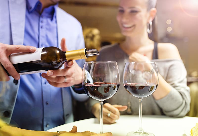 Beautiful young couple enjoying a drink in bar