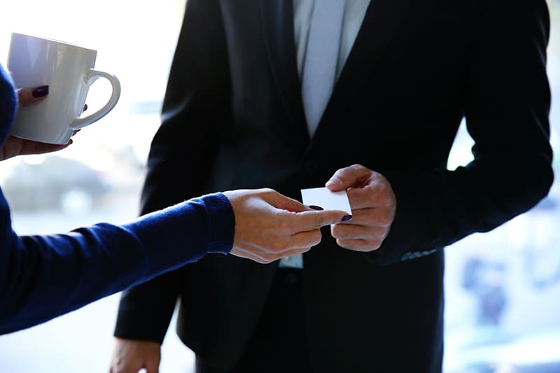 Concept shot of exchange business card between man and woman