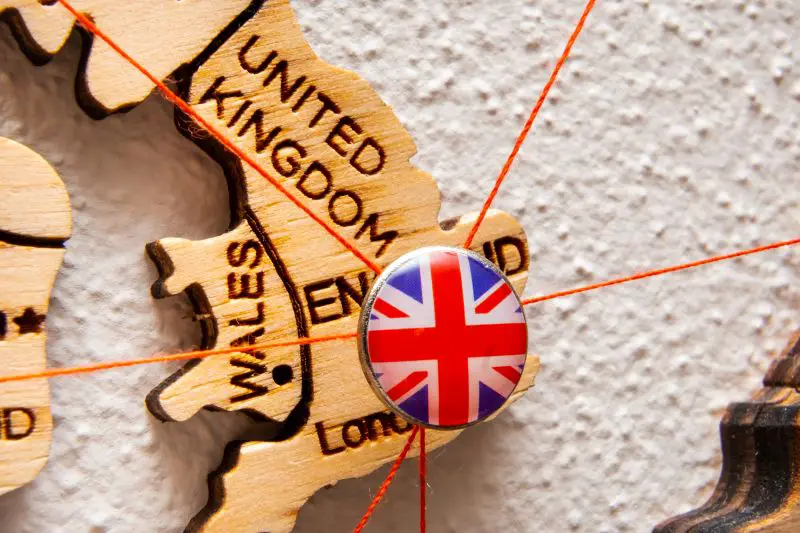 United Kindom flag on the pin with red thread showed the paths on the wooden map.