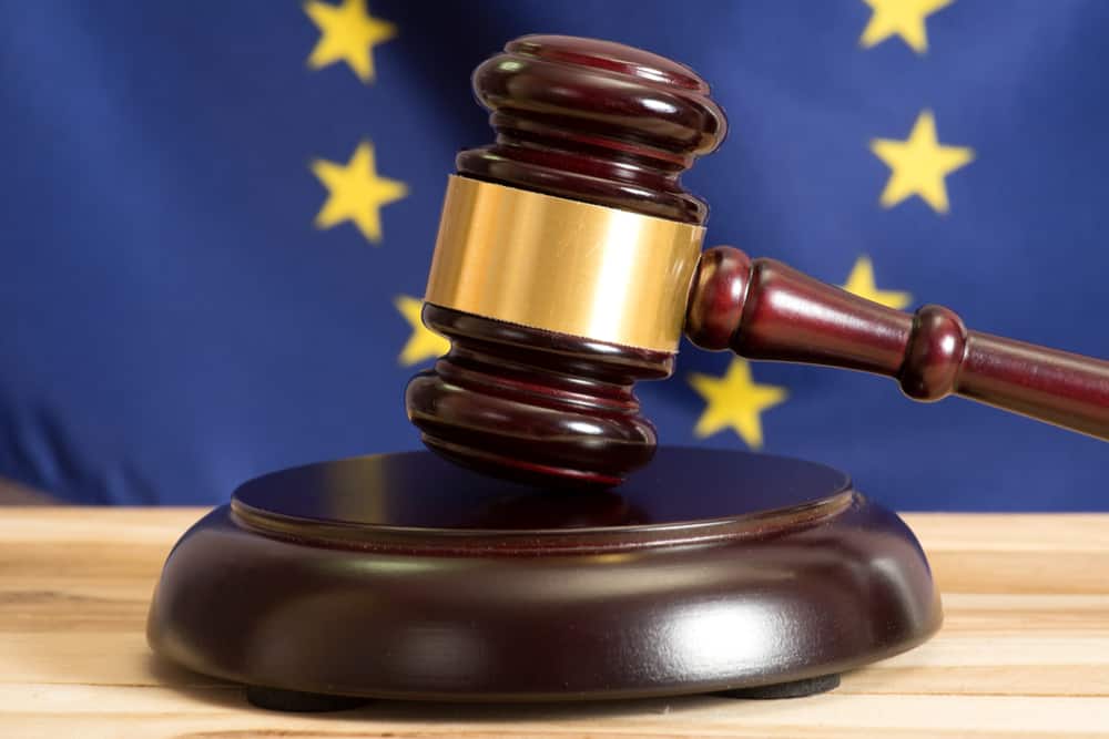 EU Law - EU flag behind gavel and block