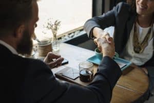 Business agreement handshake at coffee shop