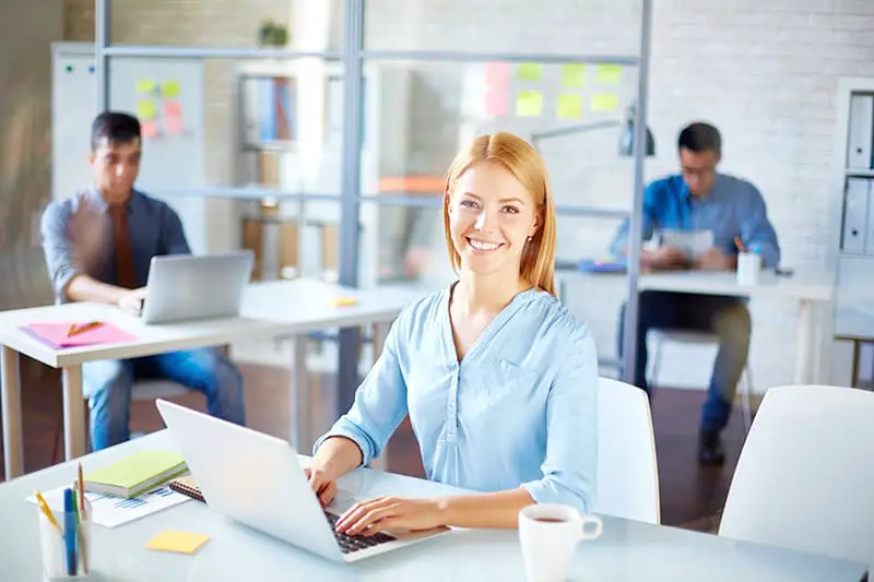 Businesswoman in casualwear looking at camera at workplace