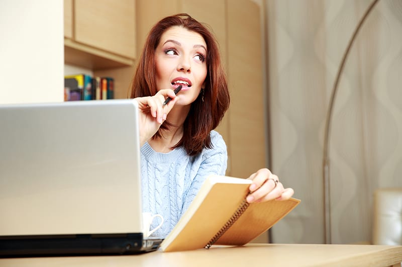 Thoughtful woman working at home