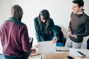 Multiracial business people working together connected with technological devices like tablet and notebook - teamwork, business, working concept