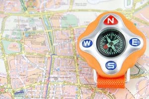 orange compass on a city map (travel/orientaion concept)