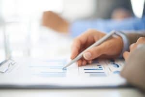 Hand of a young businesswoman working with spreadsheet