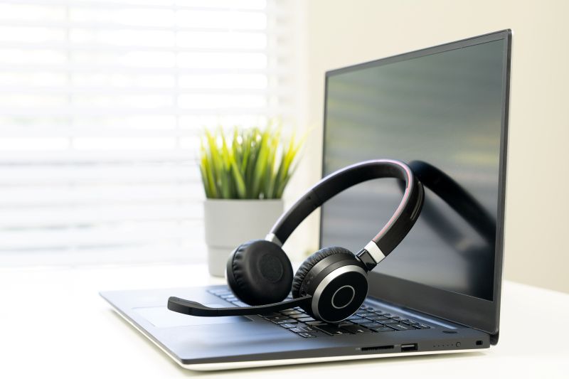 Headset on laptop in office, for workplace tech for SMEs.