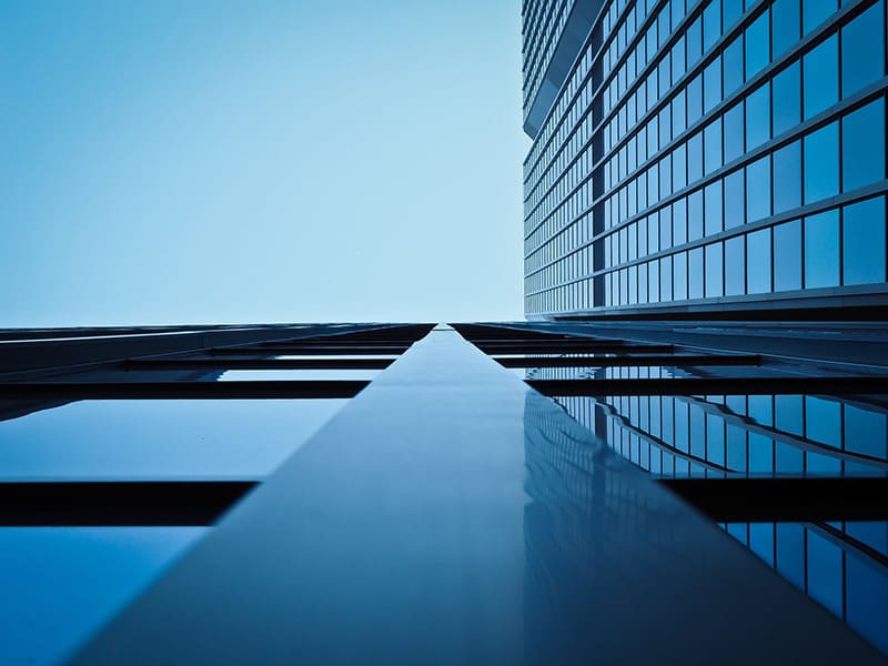 view of glass office building from ground looking up