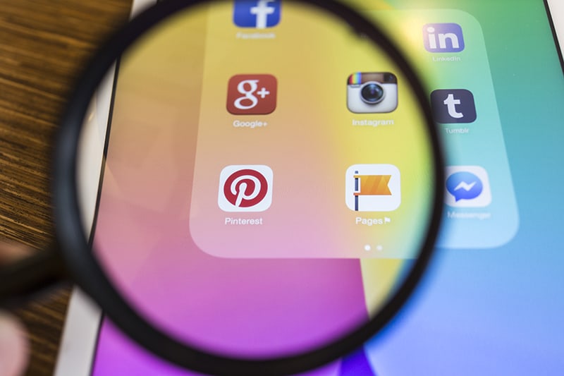 social media icons under magnifying glass