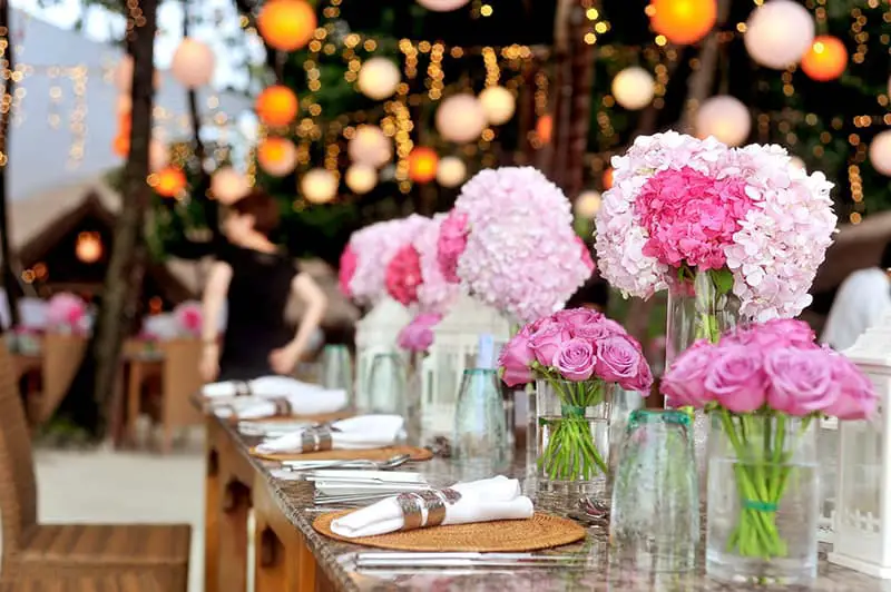 Dining table dressed with flowers, napkins and cutlery