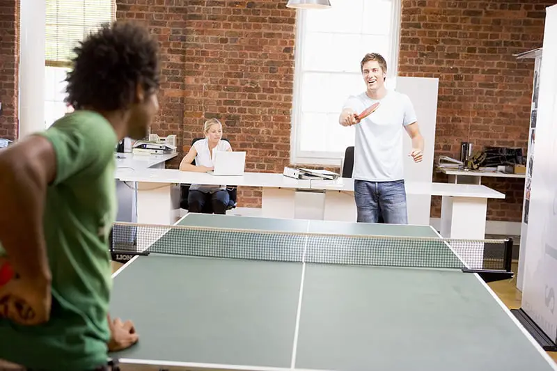 Work Perks That Your Millennial Employees Will Appreciate - Two men in office space playing ping pong