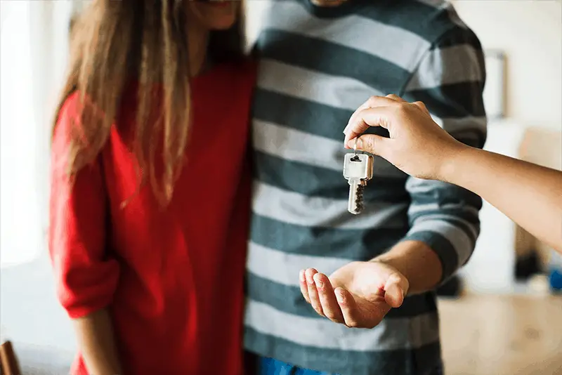 couple being handed over keys to new home