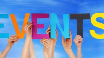 Hands holding letters spelling the word events