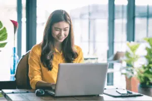 woman sat a desk using laptop computer