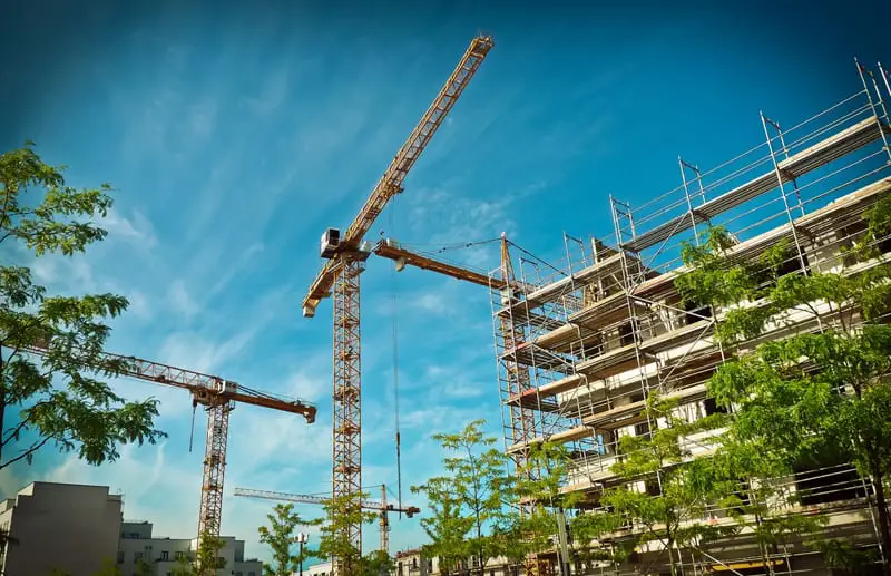 high rise building under construction, cranes