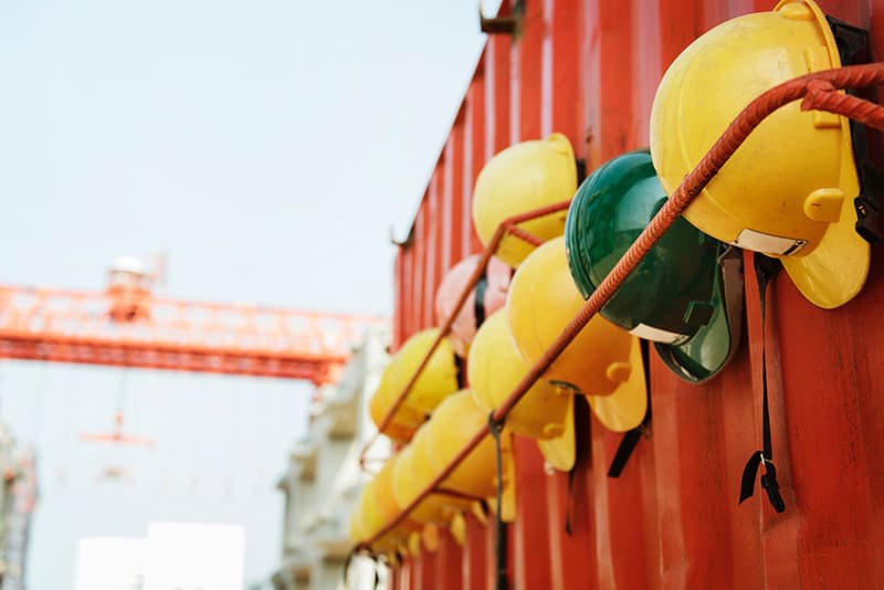 yellow and green hard hat on rack