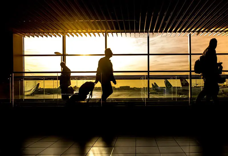 Silhouette of people in airport at dawn