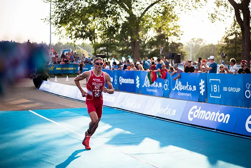 Runner running past sponsorship boards