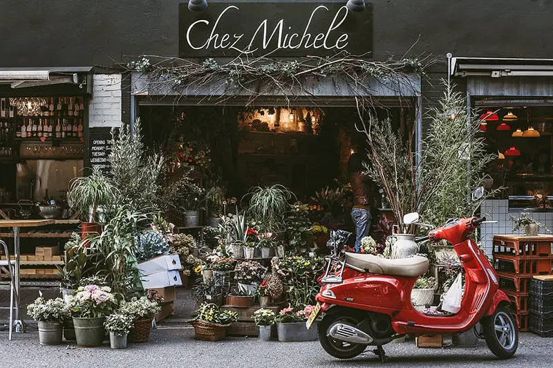 red motor scooter parked in fron of florist shop Chez Michele