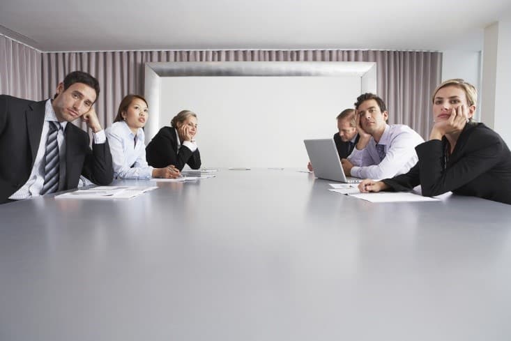 group of bored employees in a meeting room
