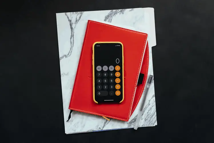 calculator on red notebook - Making Tax digital