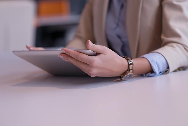 young business person using tablet and working in modern bright office