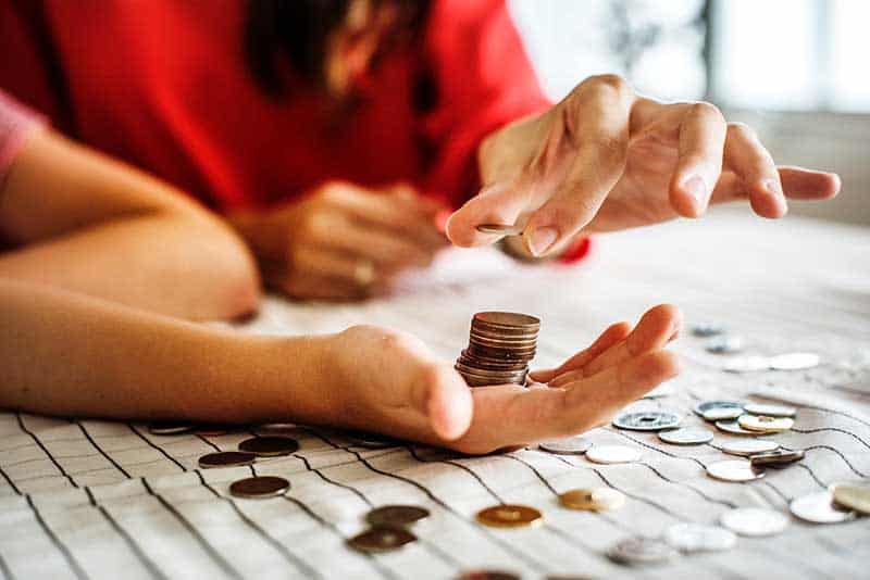 Importance of teaching financial education - mother and child counting coins