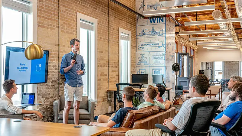 Man standing in front of a group of people doing a presentation