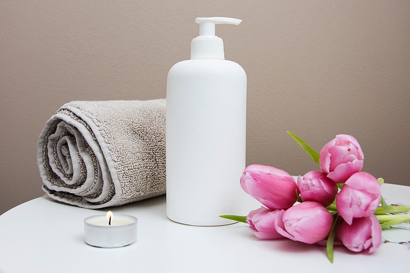 Towel, lotion, candle and flowers for Massage therapist