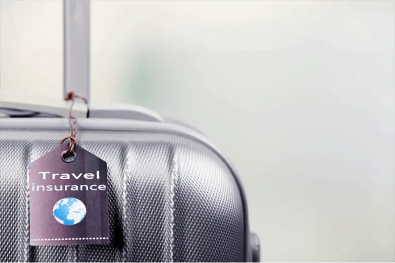 Suitcase with travel insurance tag