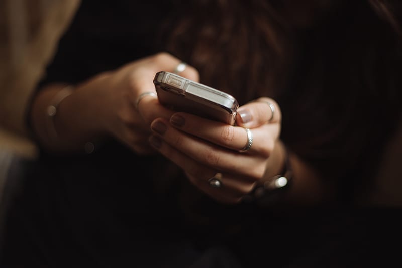 Person using smartphone to send text