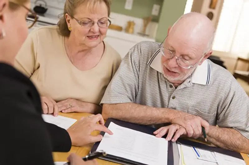 couple reviewing investment options - gold