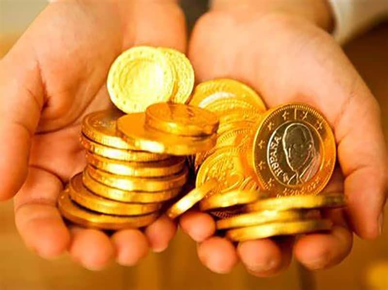 person holding gold coins - precious metals