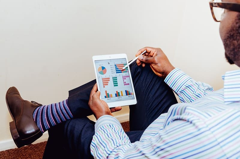 Man staying ahead of the game with price monitoring on tablet