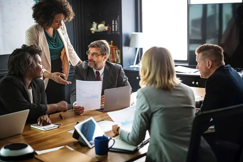 group of people having a meeting discussing price monitoring