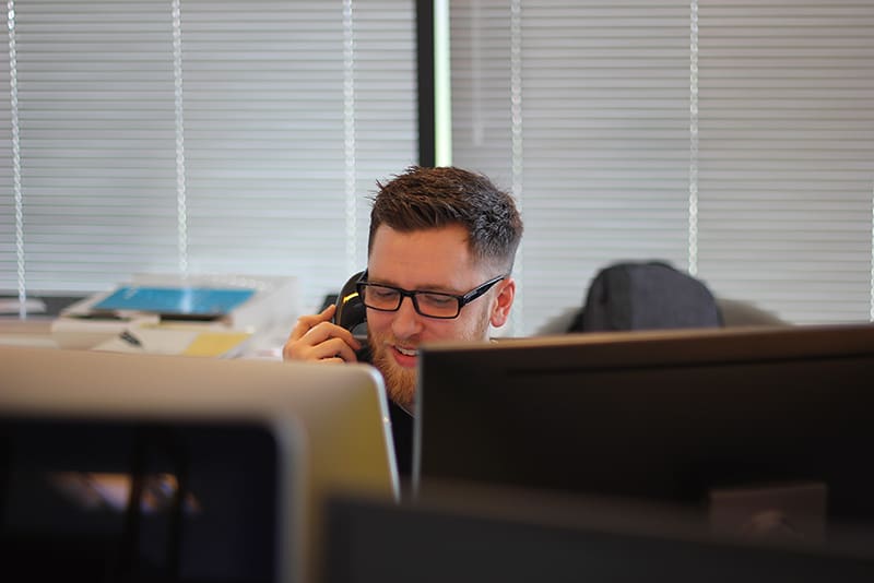 Man using landline in office