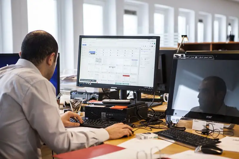 Data scientist at work - man using PC at desk