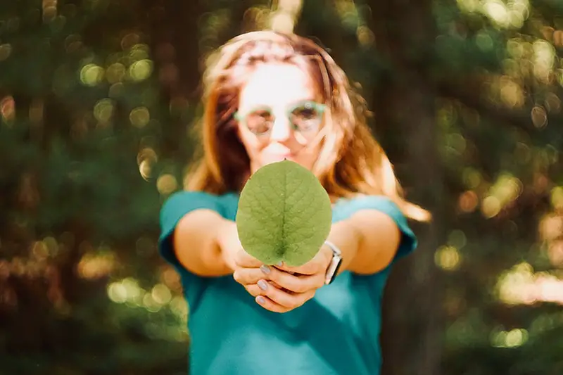 woman holding a leaf – generation green tackling climate change