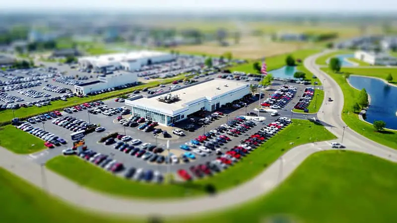 blur image of building with parking lot