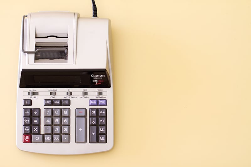 accounting calculator on yellow desk