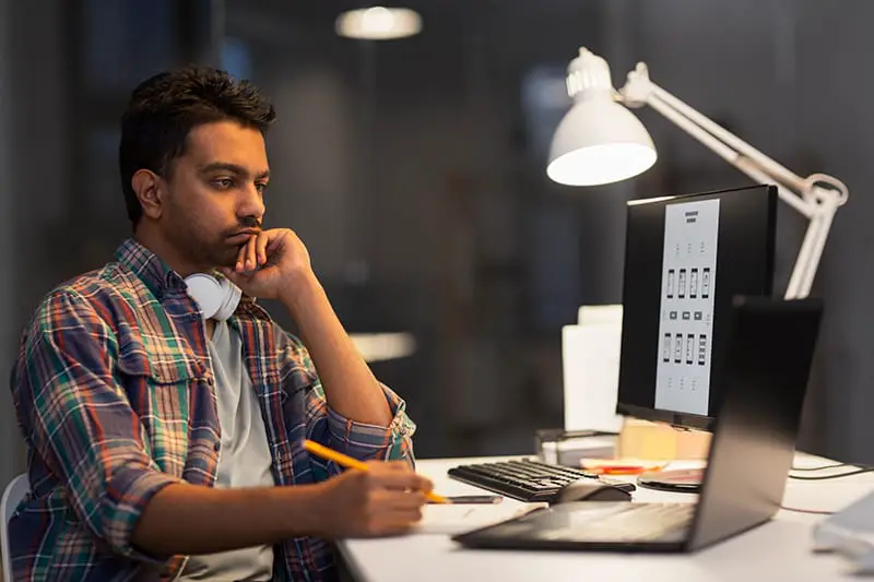 Man concentrating on some work on a computer.
