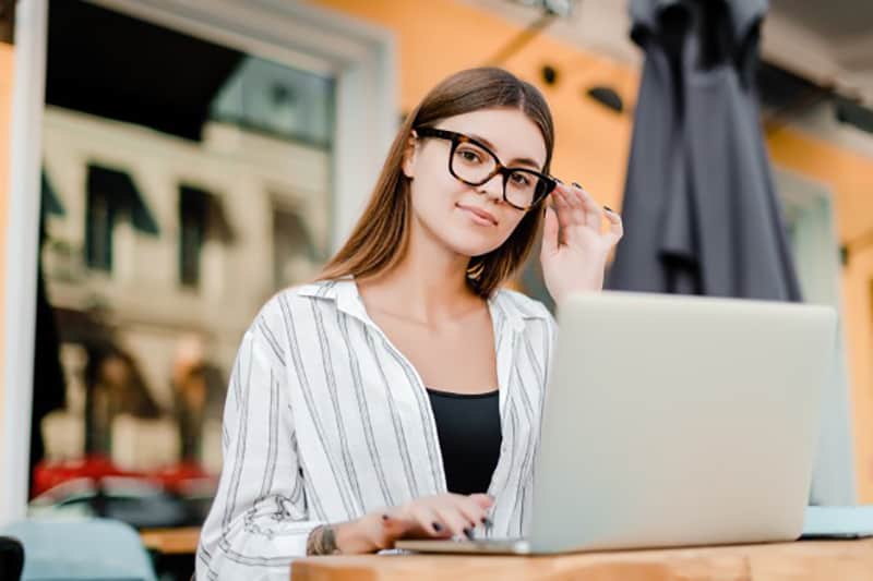 young female copywriter at work on her laptop