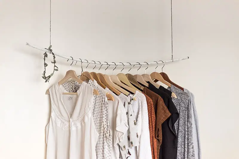 Fast fashion - clothes rail with garments hanging from it.
